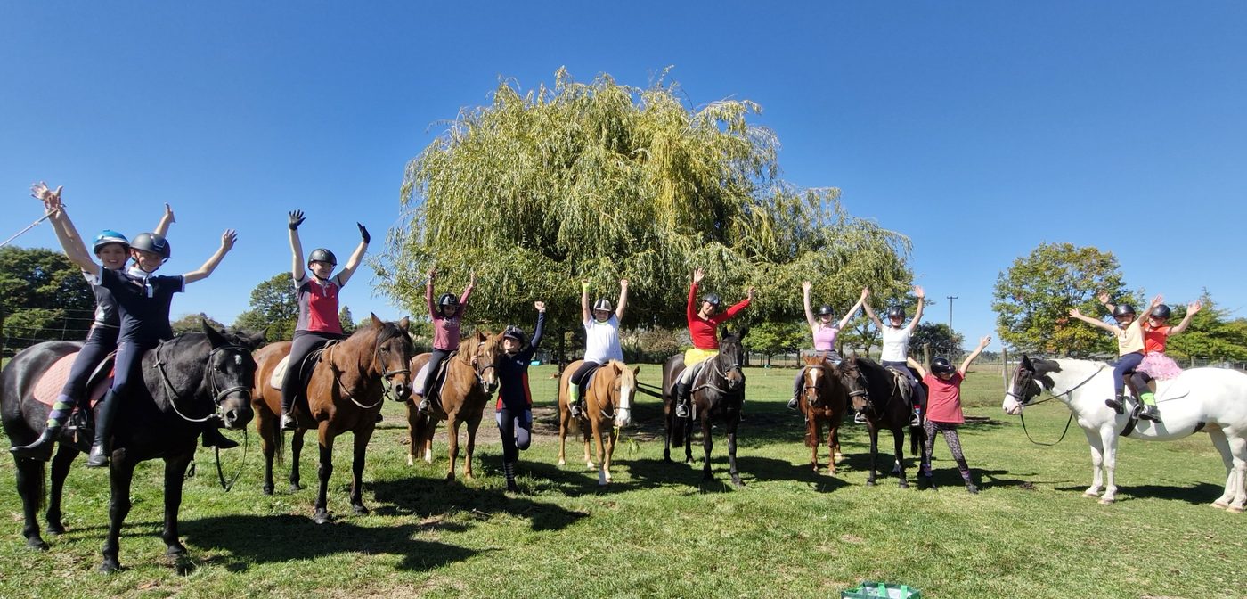 Riders celebrating together under the willow tree