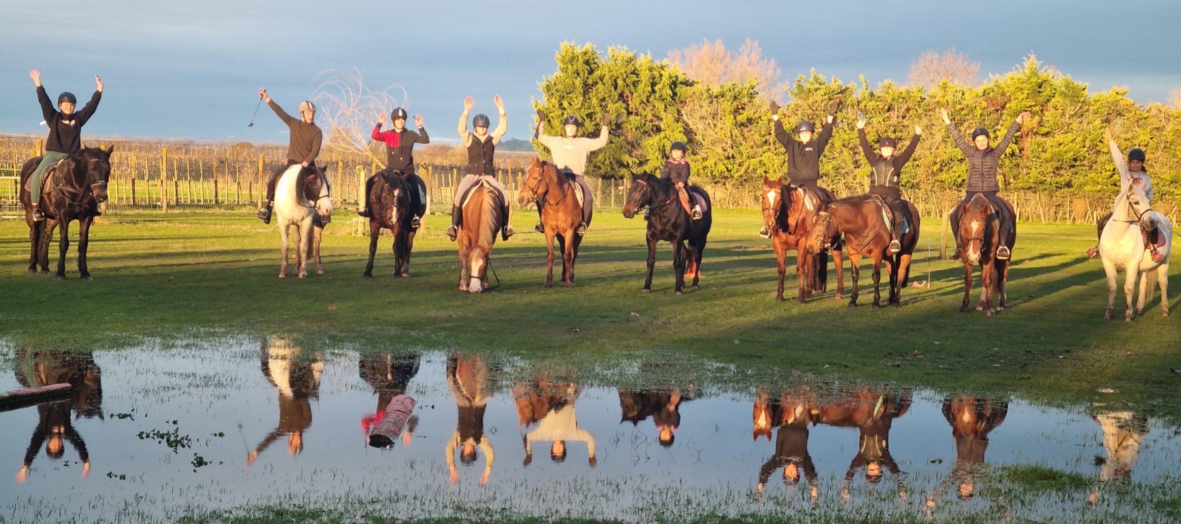 Riders and instructors at Acreswild in golden evening light